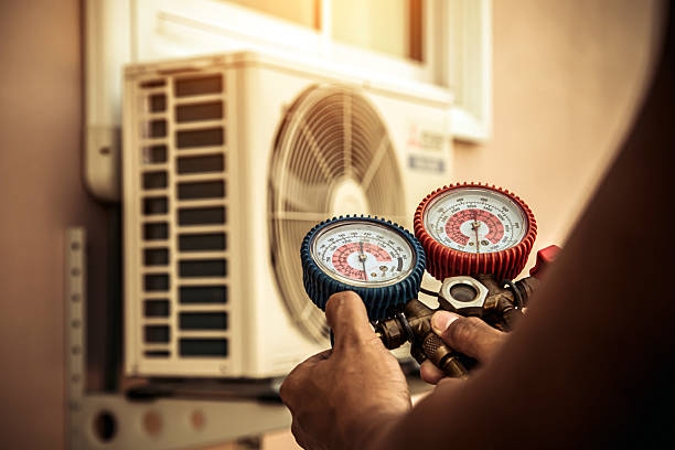 Professional Air Conditioning Service technician working in Dycusburg, KY